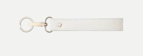 White leather keychain with gold ring on a white background