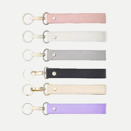 Set of five leather keychains in different colors on a white background